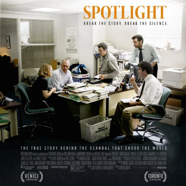 Poster for the film Spotlight, featuring five journalists gathered around a cluttered desk in an office. The tagline reads, "Break the story. Break the silence."